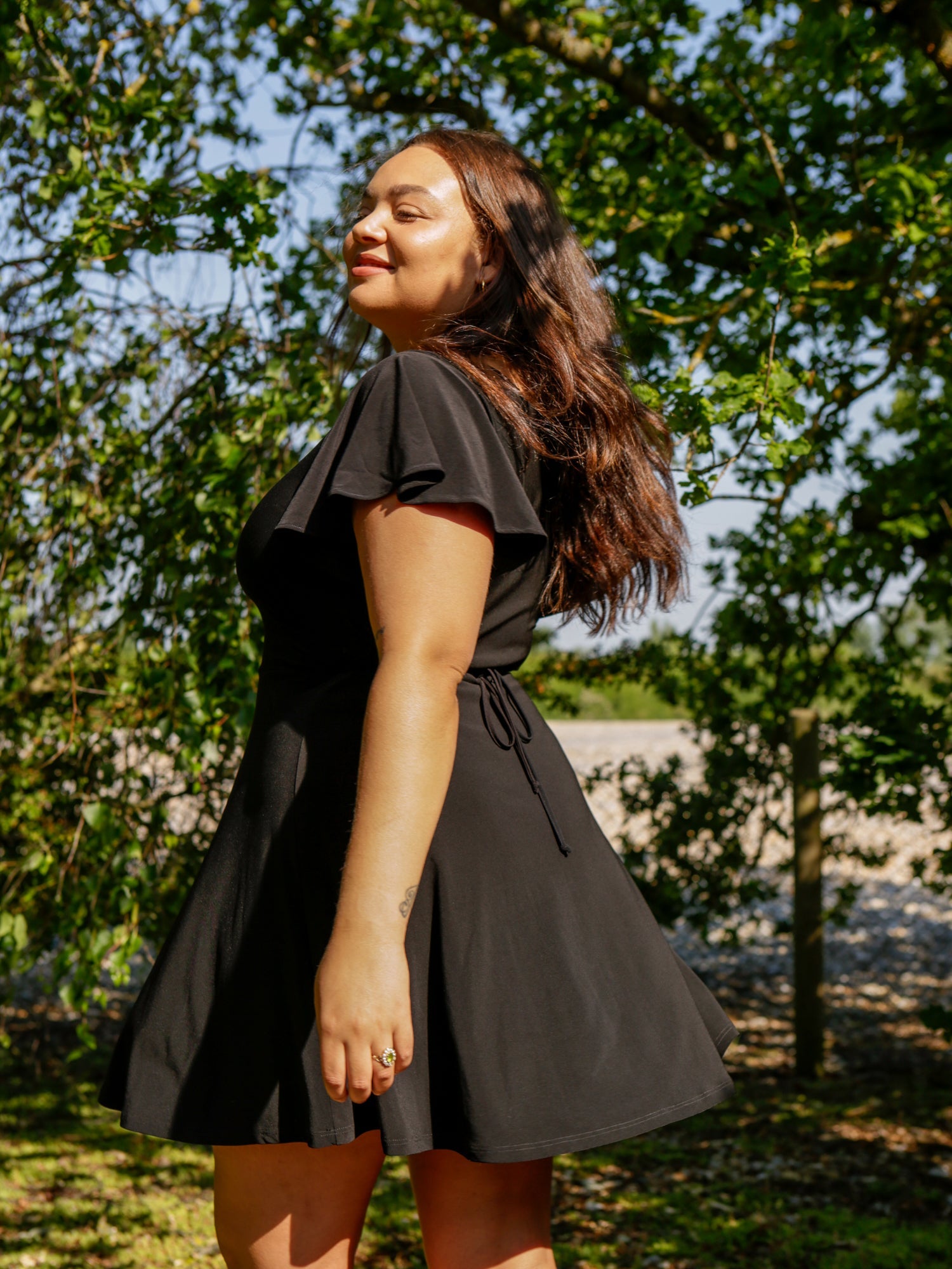 A woman in the Autumn wearing AYM Studio Ava mini black dress.