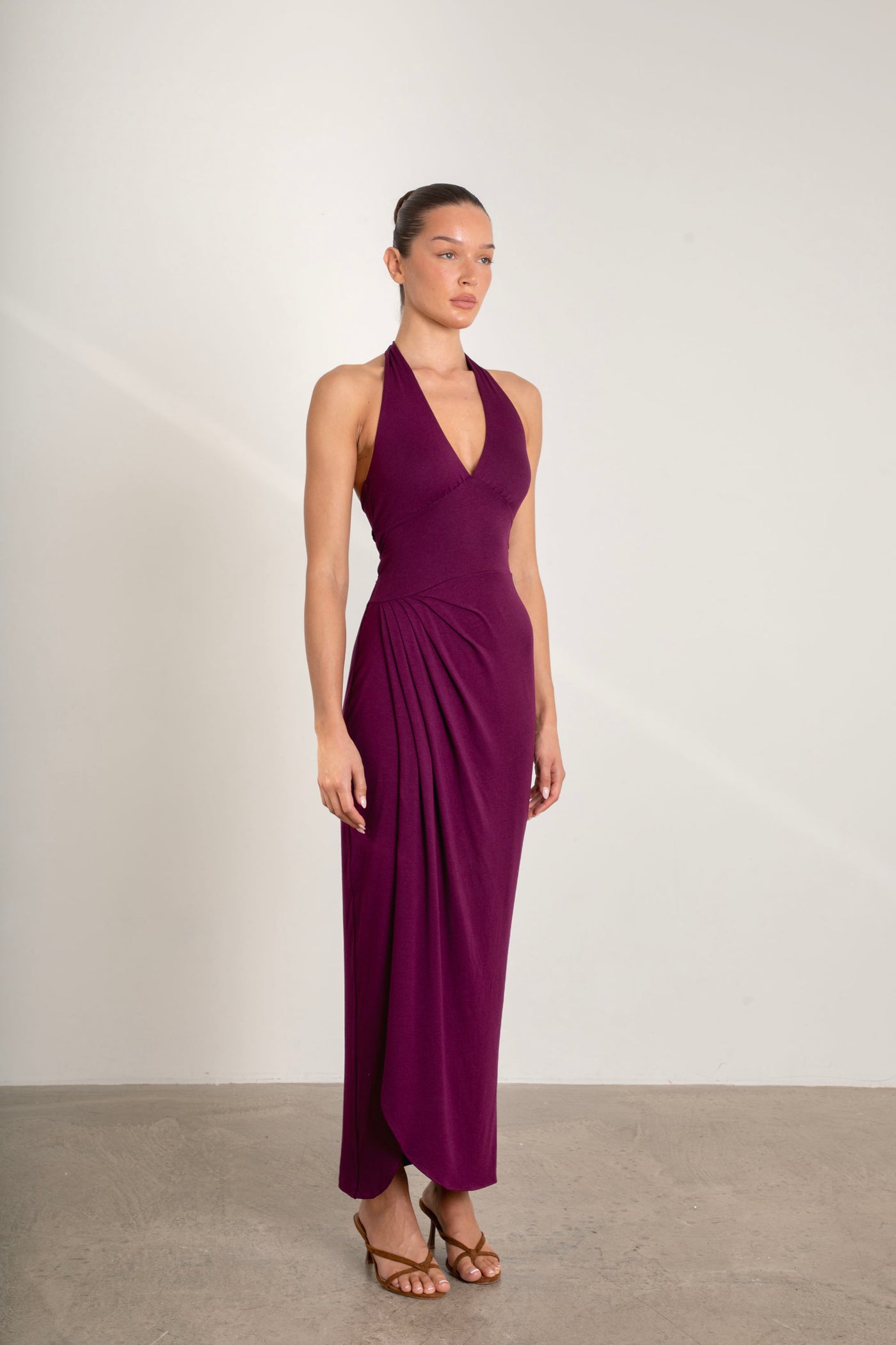 Side view of Divine Dress halterneck plum maxi dress featuring liquiddrape fabric