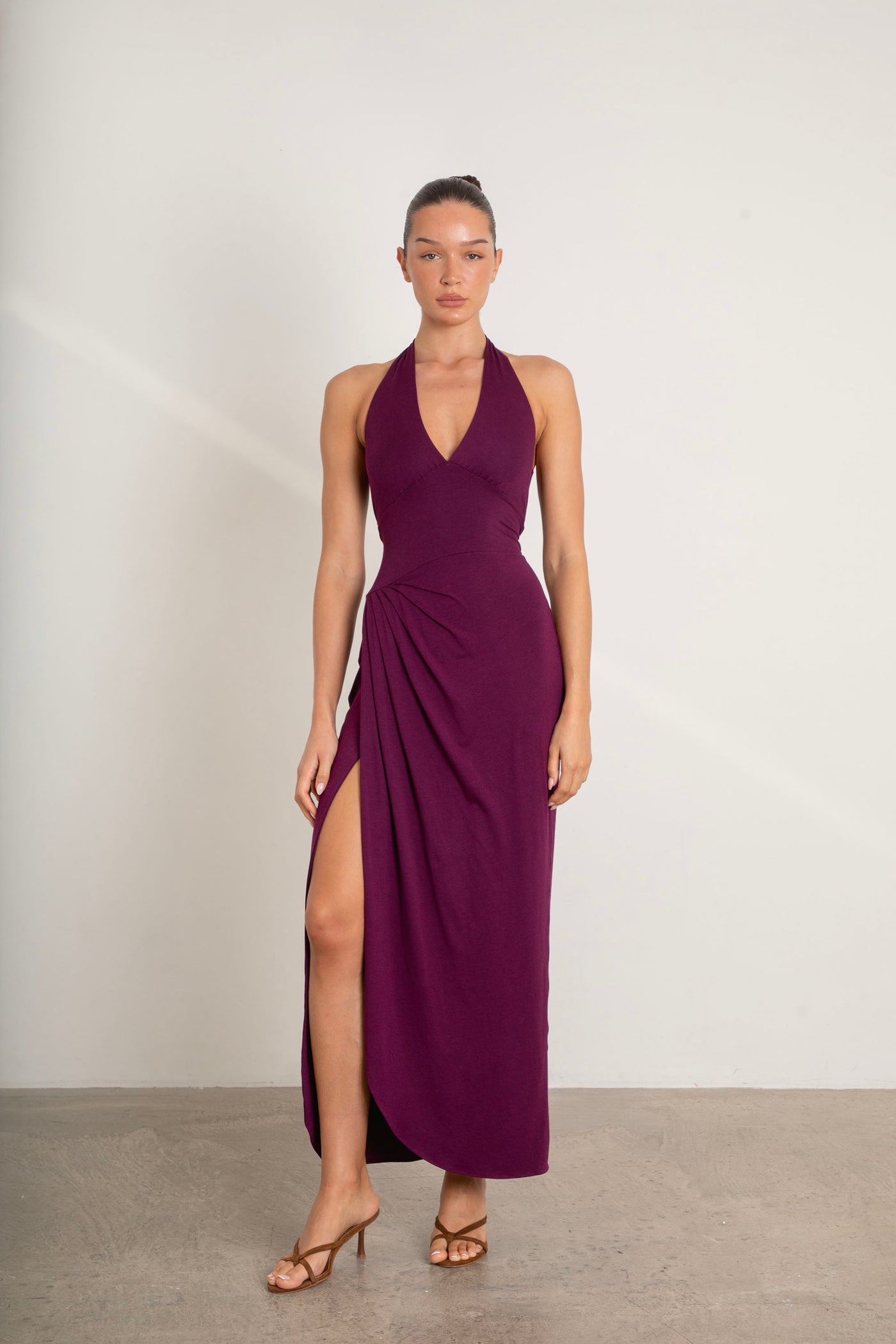 Divine Dress halterneck maxi dress in plum purple with smooth drape fabric on model